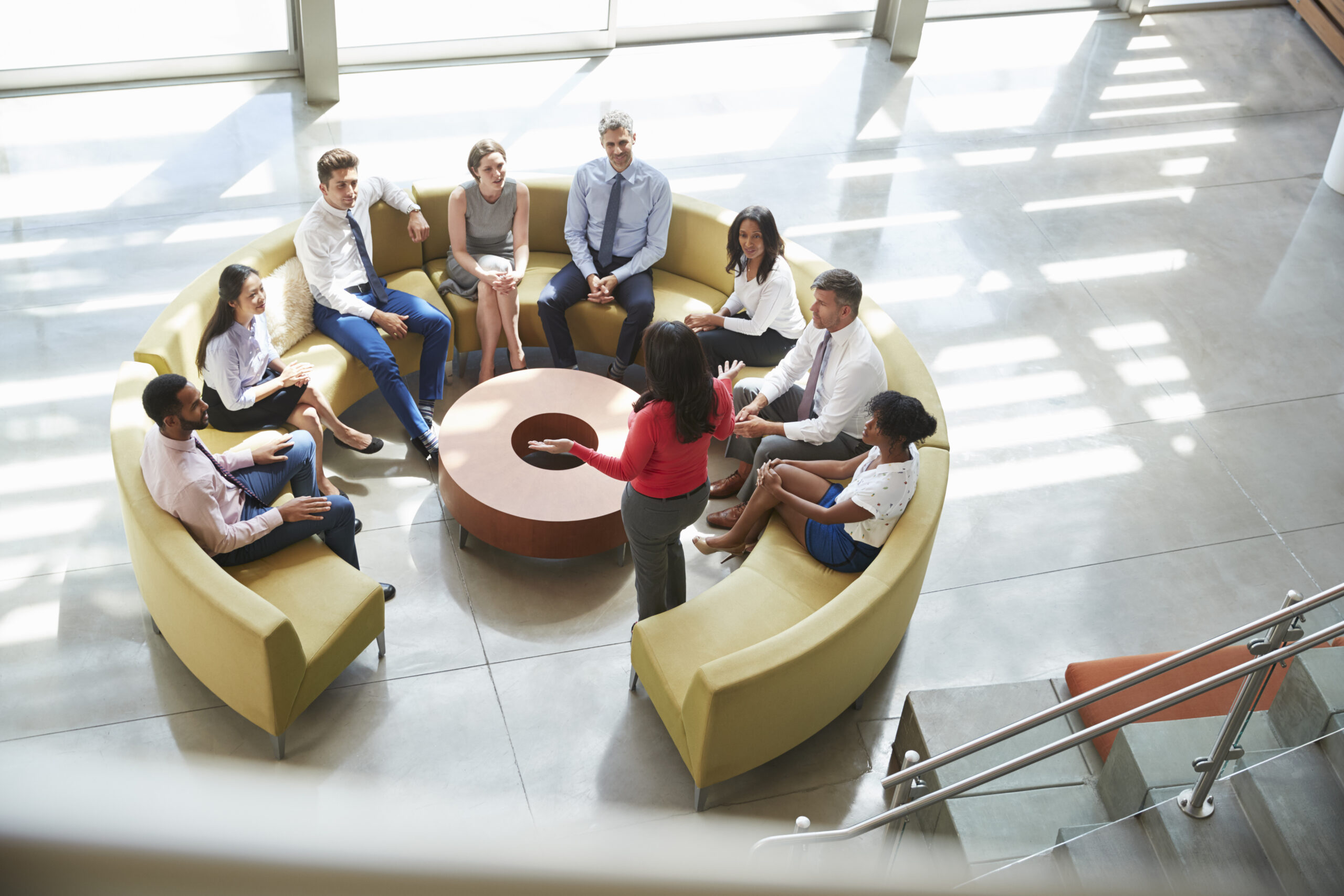 Businesswoman presenting at team meeting, elevated view
